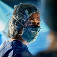 AHN surgeon wearing full facemask and shield while in surgery.